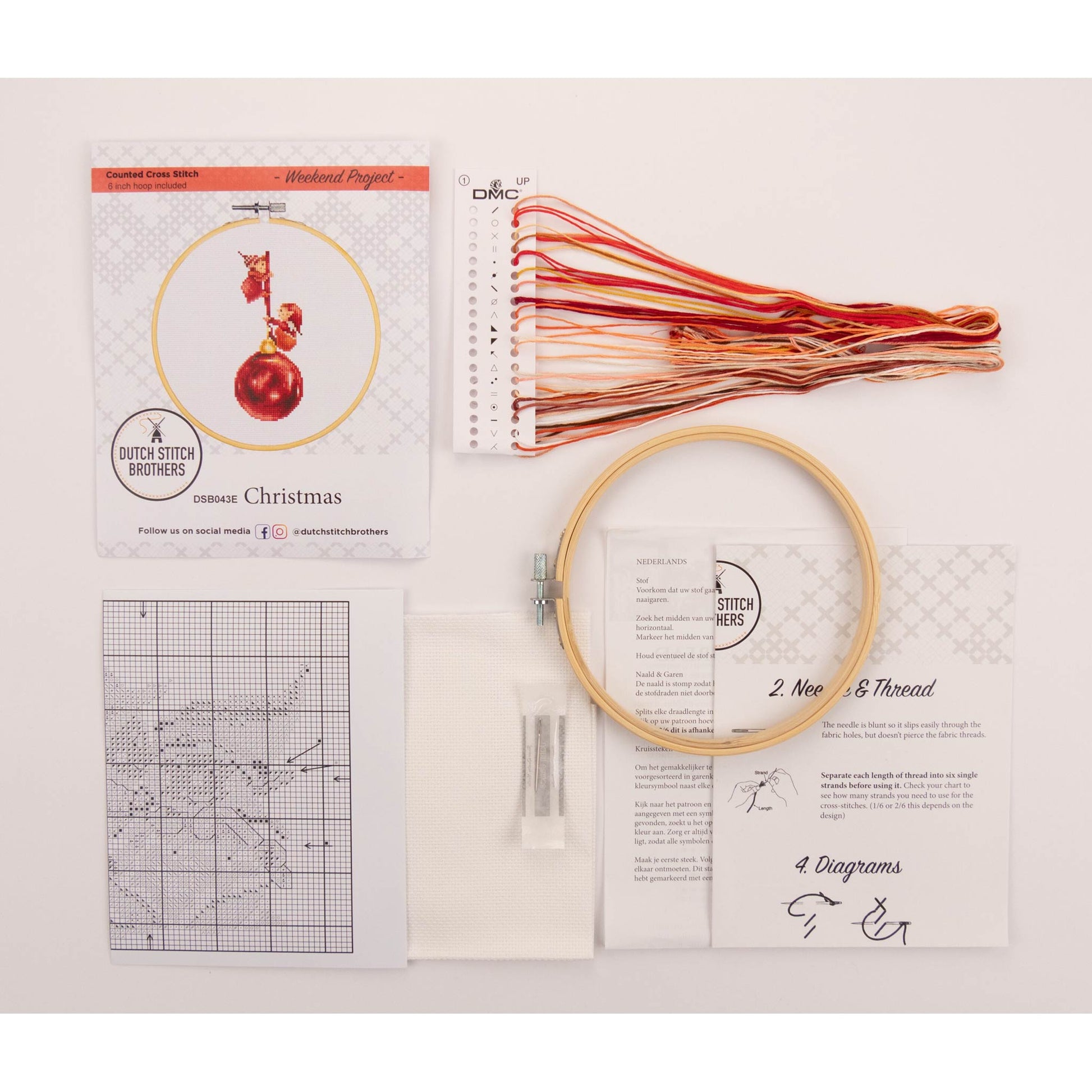 Cross stitch kit with Embroidery hoop, presorted colored thread, Aida needlework and pattern sheets on a light background