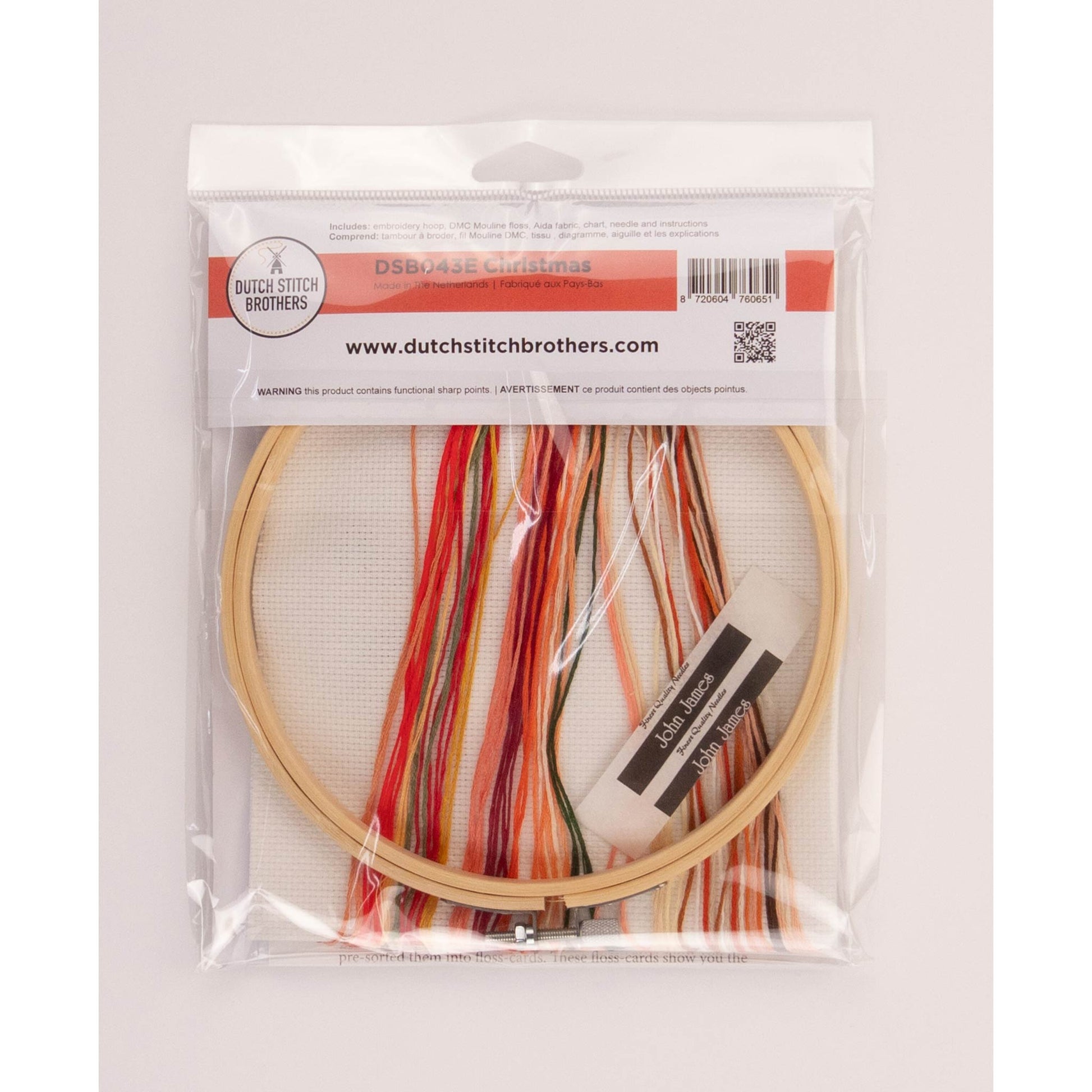 Cross stitch kit packageEmbroidery hoop, colorful threads and tools in clear packaging, branded 'Dutch Stitch Brothers'