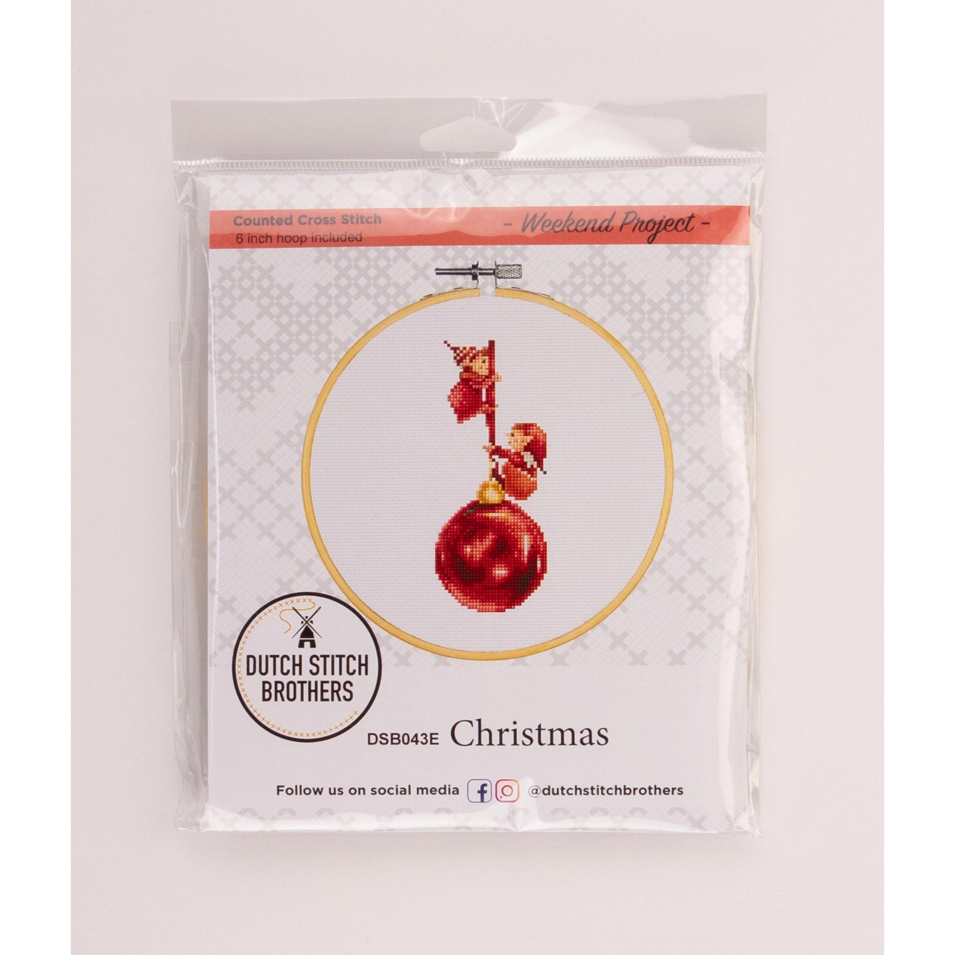 Packaged Christmas elves-themed cross-stitch kit with a red ornament design on a white background.