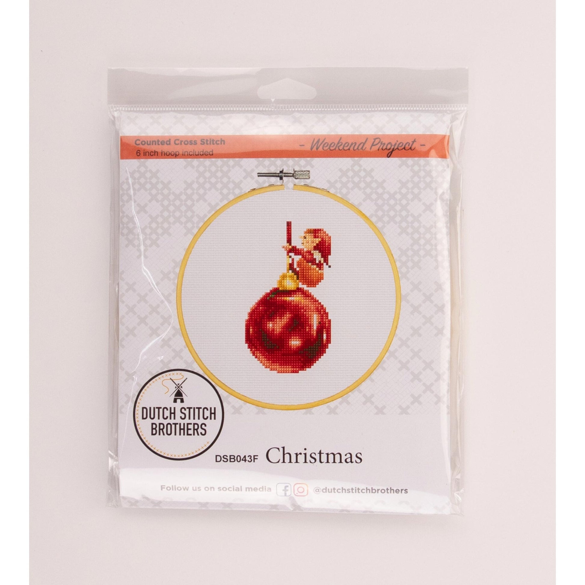 Cross-stitch kit packaging with a red Christmas ornament design Dutch Stitch Brothers brand.